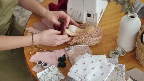 Trying on ready-made clothes for the doll. Making handmade puppets 库存影片 230992745