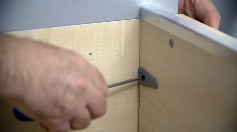 Trying to screw a screw into the wardrobe frame Stock Footage 34663217