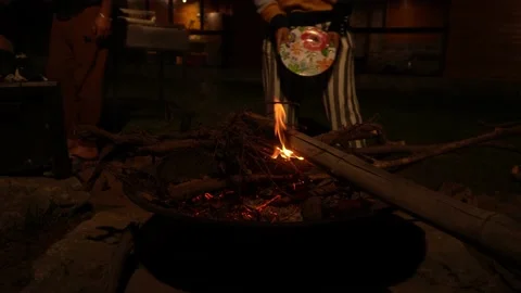 Trying to start a poor fire with a plate giving air and putting it out completel Video stock 199530530