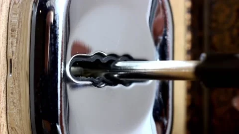 Trying to turn the broken key in the keyhole with no result close up Stock Footage 233500319