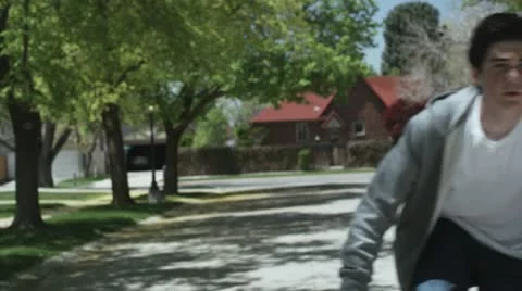 TS, MS, ZI, ZO, boy riding his bike down a street Stock Footage 10703308