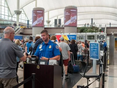 TSA agent passes man through security checkpoint at Denver International Airport Stock Photos