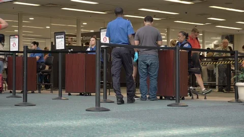 TSA Airport Security Agent Checks Passenger Ticket Information Stockbeeldmateriaal 108698205