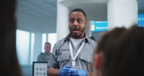 TSA Security Officer Instructs Passengers About Metal Detector Scanner Gates Stock Footage 306687916
