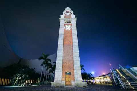 The Tsim Sha Tsui Clock Tower at night, in Kowloon, Hong Kong. Stock Photos