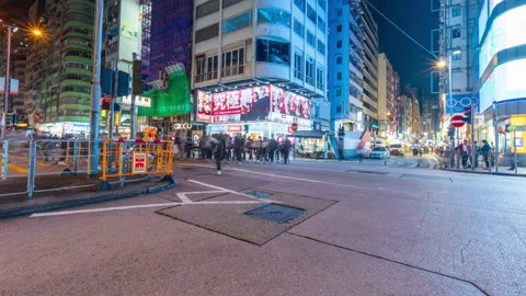 Tsim Sha Tsui road Traffic light while tourist walk on croswalk at night Stock Footage 274064264