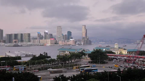 Tsim Sha Tsui view across Victoria Harbour at dusk, Hong Kong skyline Stock Footage 309439834