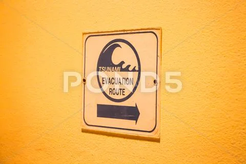 Tsunami evacuation route sign on up stair way Stock Photos