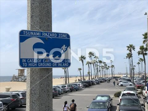 Tsunami Hazard Zone sign with parking and beach background Stock Photos