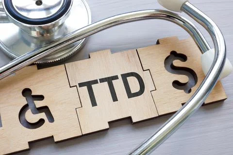 TTD Temporary total disability abstract. Puzzle pieces and a stethoscope. Stock Photos