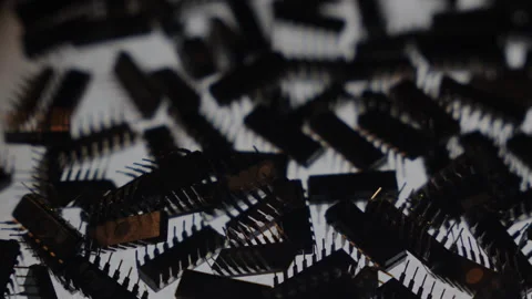 TTL IC Chips Pile Side View Rotating Shallow DOF Bokeh Cold Backlit Stock Footage 331067332