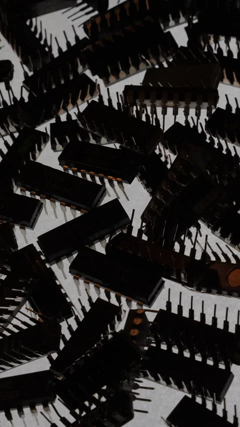TTL IC Chips Pile Top Down Rotating Cold Backlight Silhouette Stock Footage 331042035