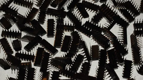 TTL IC Chips Pile Top Down Rotating Cold Backlight Silhouette Stock Footage 331067337