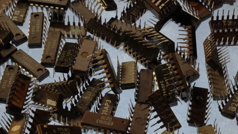 TTL integrated circuits rotating on turntable, top view, warm key, cold backlit Stock Footage 331040210