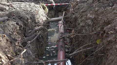 Ttrench is filled with sewage.Replacing the sewer pipe in the city. Stock Footage 166397527