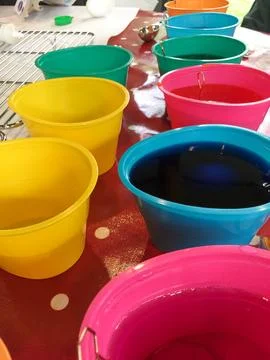 Tub of Easter Egg Dye with Eggs Sitting in Them Stock Photos