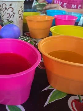Tub of Easter Egg Dye with Eggs Sitting in Them Stock Photos