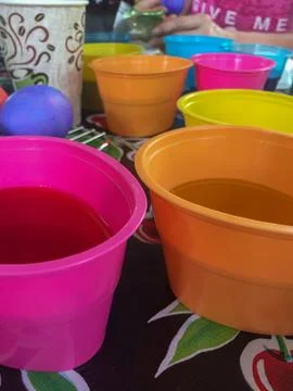 Tub of Easter Egg Dye with Eggs Sitting in Them Stock Photos