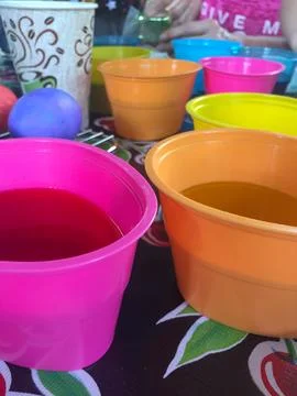 Tub of Easter Egg Dye with Eggs Sitting in Them Stock Photos