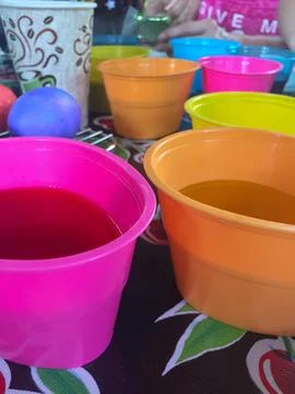 Tub of Easter Egg Dye with Eggs Sitting in Them Stock Photos