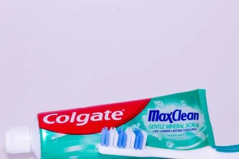 A tube of Colgate max clean toothpaste and toothbrush against a white backgro Stock Photos