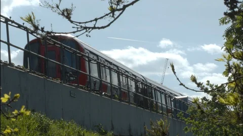 A tube train approaches camera along a section of raised track. Video stock 107673353