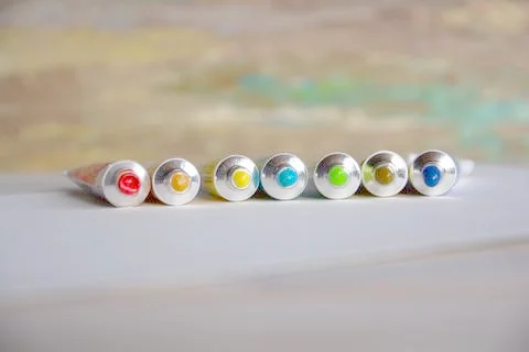 Tubes close-up with bright multi-colored watercolors blue, yellow, green shad Stock Photos