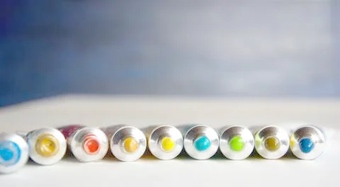 Tubes close-up with bright multi-colored watercolors blue, yellow, green shad Stock Photos