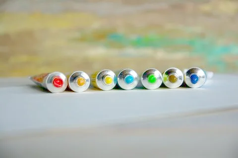 Tubes close-up with bright multi-colored watercolors blue, yellow, green shad Stock Photos