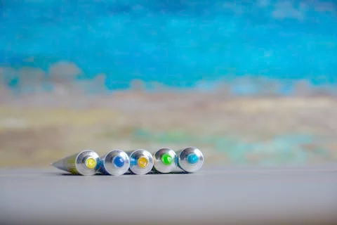 Tubes close-up with bright multi-colored watercolors blue, yellow, green shad Stock Photos