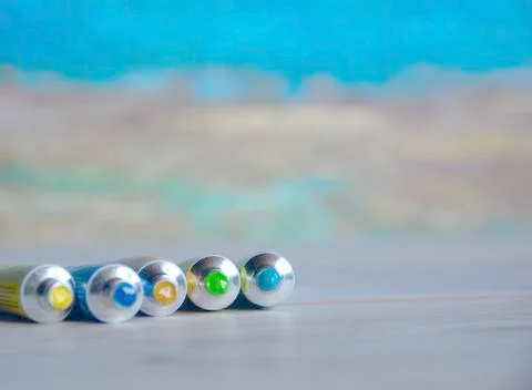 Tubes close-up with bright multi-colored watercolors blue, yellow, green shad Stock Photos