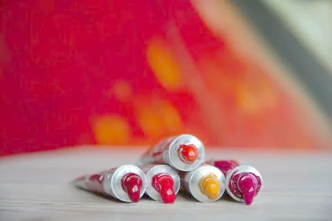 Tubes close-up with bright multi-colored watercolors red shades. Good backgro Stock Photos