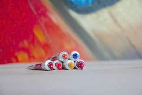 Tubes close-up with bright multi-colored watercolors red shades. Good backgro Stock Photos