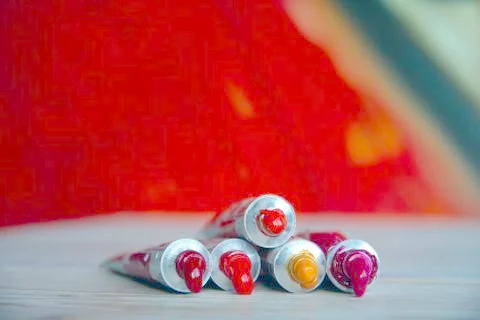 Tubes close-up with bright multi-colored watercolors red shades. Good backgro Stock Photos