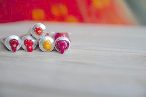 Tubes close-up with bright multi-colored watercolors red shades. Good backgro Stock Photos