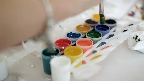 Tubes of colored paint on the table. Brush dipped in paint. Creative hobby. Stock Footage 115959026