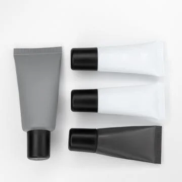 Tubes with cosmetics on a white background. Stock Photos