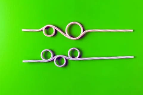 Tubes for drinks on a green background macro. place for the label Photos