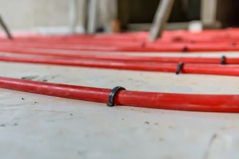 Tubes of the underfloor heating system on a styrofoam insulation Stock Photos