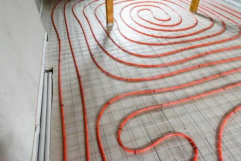 Tubes of the underfloor heating system on a styrofoam insulation Stock Photos