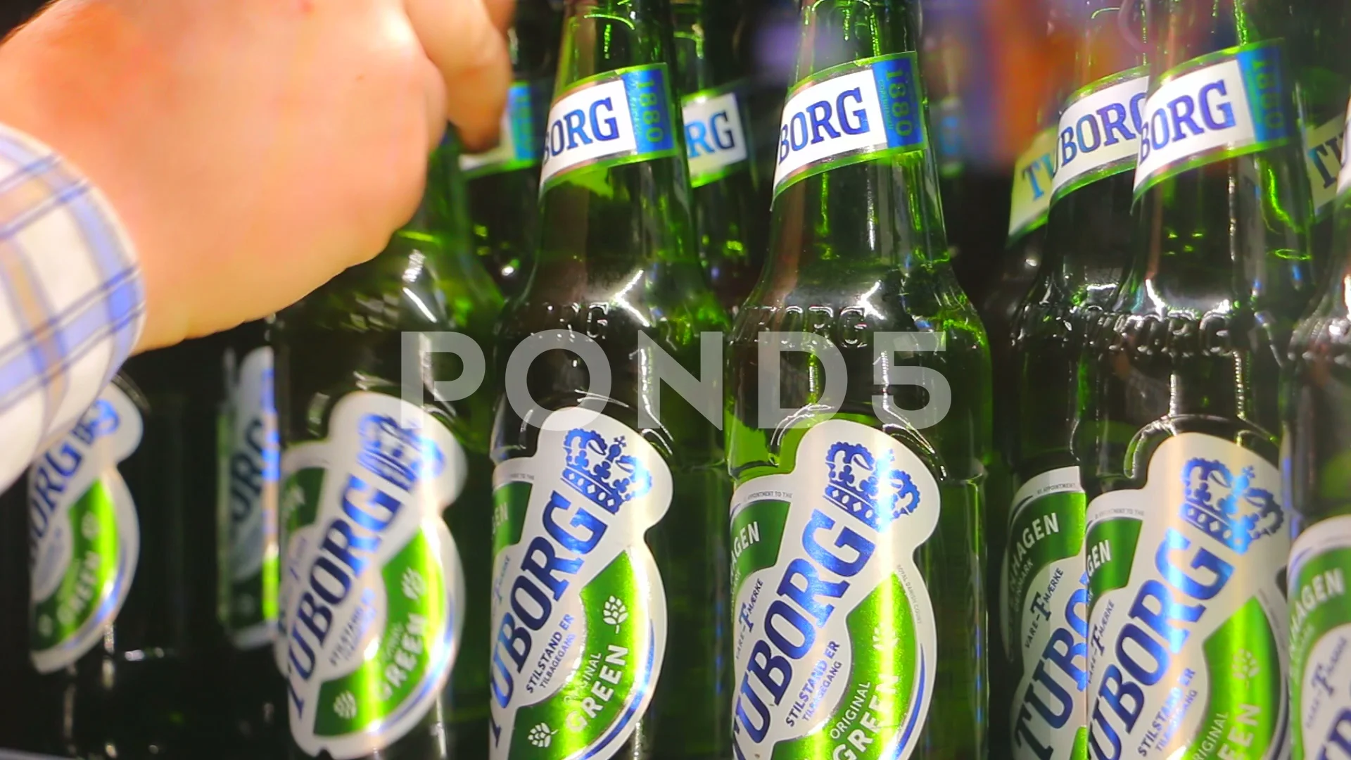 Tuborg beer. Taking a tuborg beer from t... | Stock Video | Pond5