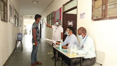 Tudents going through Temperature check and  at examination  center Stock Footage 139379663