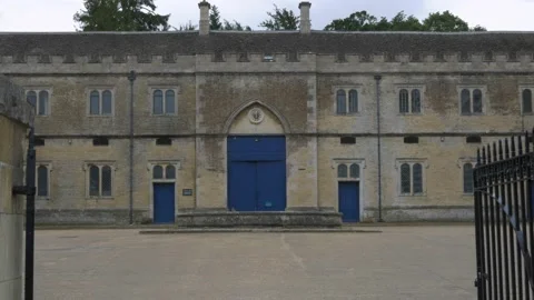 Tudor mansion stable house with empty yard. Hand held overcast day Stock Footage 134790161