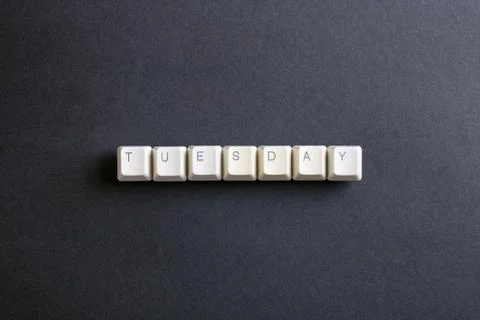 Tuesday word on computer keys button on a dark background. Foto stock
