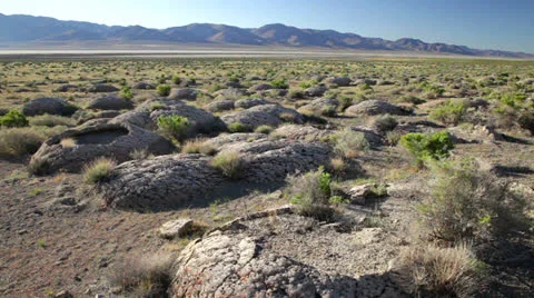 Tuffa rock formations next to dry lake bed in western desert, sunrise, 995 Stock Footage 23831454