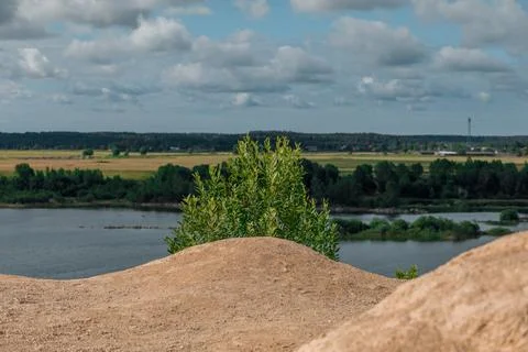 Tuffets and the sky with white clouds with the lake far away Stock Photos