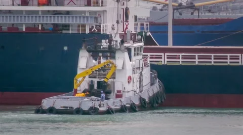 Tug assisting ship in mooring operations Video stock 67565536
