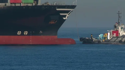 Tug boat assists container ship Stock Footage 72964329