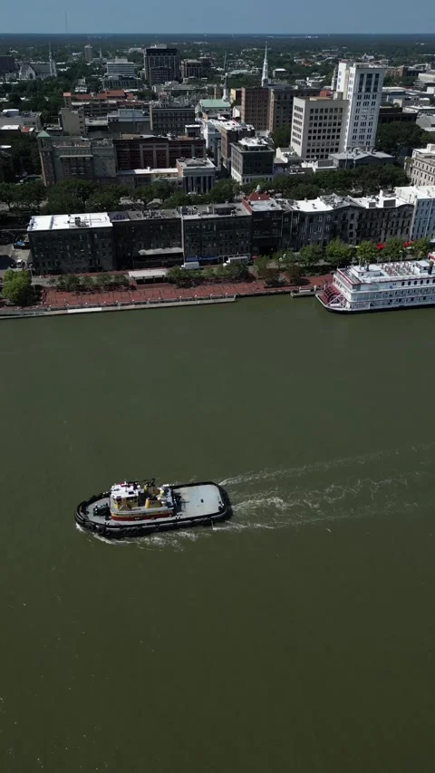 Tug boat going down the river in Savannah, GA Stock Footage 247777228