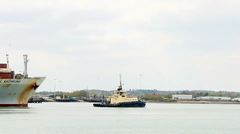 Tug boat pulling a container ship real time 1 Stock Footage 46074582